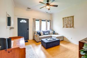 a living room with a couch and a ceiling fan at Quaint Home with Yard about 4 Mi to Downtown Louisville! in Louisville