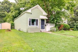 a small green house with a grass yard at Quaint Home with Yard about 4 Mi to Downtown Louisville! in Louisville