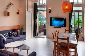 a living room with a couch and a table at Panorama apartment Briancon in Briançon