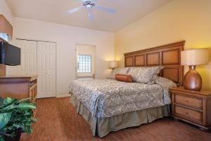a bedroom with a bed and a flat screen tv at WorldMark Rancho Vistoso in Oro Valley