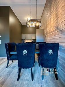 a dining room with a table and blue chairs at New high standard apartment in Trysil alpine lodge in Trysil