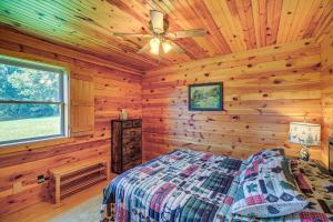um quarto com uma cama num chalé de madeira em Blue Ridge Mountain Cabin with Views and Hot Tub em Sparta