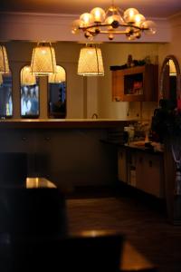 a kitchen with two chandeliers and a counter top at Pearl Hotel İstanbul in Istanbul