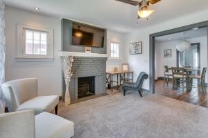 a living room with a fireplace and a dining room at Charming Springfield Home 2 Mi to Downtown in Springfield