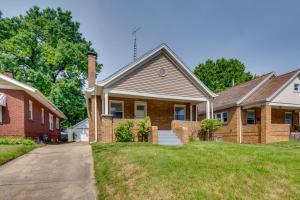 a brick house with a driveway in a residential neighborhood at Charming Springfield Home 2 Mi to Downtown in Springfield