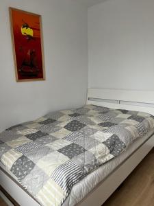 uma cama num quarto com uma fotografia na parede em Apartment beim Lennox em Puck