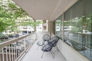 a balcony with two chairs and a table at Luxury apartment at Crystal City with Amazing Amenities in Arlington