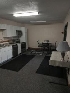 an empty room with a kitchen and a table at E. Michigan Walk Up Furnished 2 Bedroom APT in Lansing