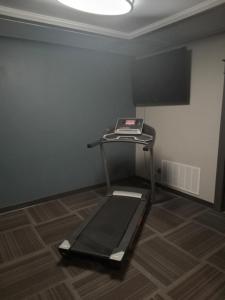 a room with a treadmill in the corner of a room at E. Michigan Walk Up Furnished 2 Bedroom APT in Lansing