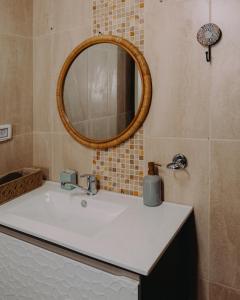 a bathroom with a white sink and a mirror at Hippie house בית היפי in Mitzpe Ramon