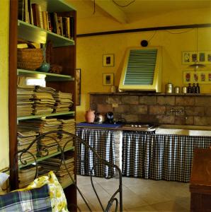 a kitchen with a table and a counter with books at La Traversina in Stazzano