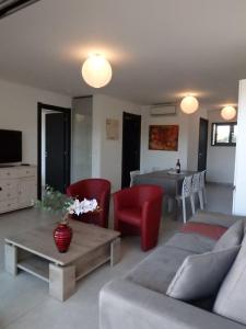 a living room with a couch and a table at Appartement Cité Du Sel in Porto-Vecchio