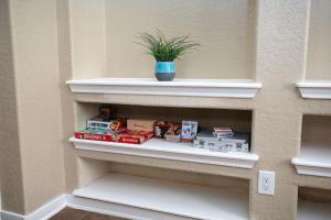 a shelf with food and a potted plant on it at Cibolo Sa Getaway Wi-fi Bbq Games Parking in Cibolo