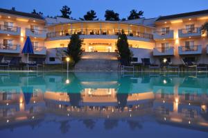 a hotel with a swimming pool at night at Kohylia by La Scala Beach in Limenas