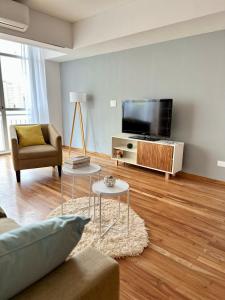 a living room with a couch and a flat screen tv at Great Apartment in Recoleta in Buenos Aires
