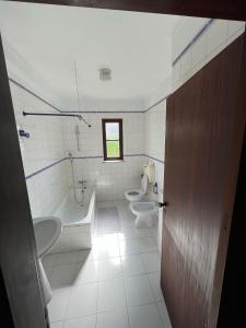 baño con 2 lavabos, bañera y 2 aseos en A place in the sun, en Longueira