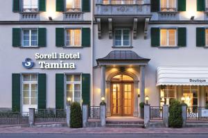 a hotel room with a large white building behind it at Sorell Hotel Tamina in Bad Ragaz