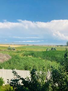 a field with a fence in the middle of it at Гостевой дом с панорамными окнами in Gyumri