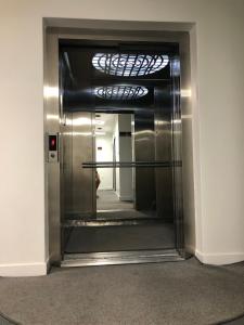 a hallway with a metal elevator in a building at Kubi Hotel in Struga