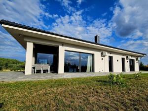 a large white house with a large patio at Willa Skrzatusz in Skrzatusz