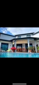 a house with a swimming pool in front of it at la villa TIKALIKATA in Saint-Joseph