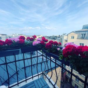 a balcony filled with flowers on top of a building at Senate Hotel in Helsinki