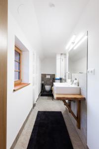 a bathroom with a large white sink and a mirror at Zimmer am Weinberg in Deutschlandsberg