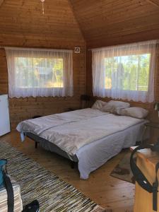 a bedroom with a bed in a log cabin at Hortensia in Mariehamn