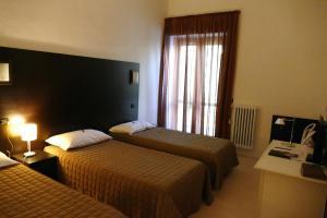 Кровать или кровати в номере Hotel Colucci