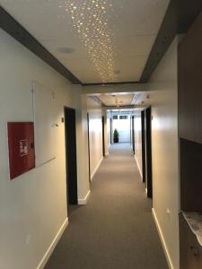 a hallway of an office building with a ceiling with lights at Kubi Hotel in Struga