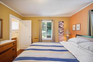 a bedroom with a bed and a window at Charming Pet Friendly Coastal Getaway home in Fort Bragg