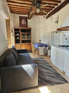 a living room with a couch and a table at "Castel D Arno Guest House Assisi Perugia" in Pianello