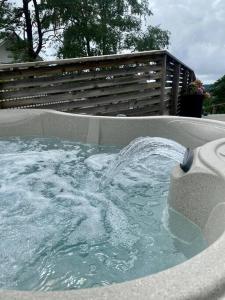 a bath tub filled with water in a yard at Villalägenhet i Askim med havsutsikt in Gothenburg