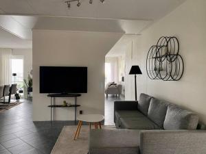 a living room with a couch and a flat screen tv at Villalägenhet i Askim med havsutsikt in Gothenburg