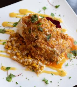 a plate of food with a meatball and corn at Baton Rouge Marriott in Baton Rouge