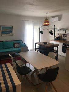 a living room with a table and chairs at Land and Sea in Primošten
