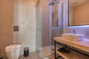 a bathroom with a toilet and a sink and a shower at Liberdade Concept 1BDR Apartment by LovelyStay in Lisbon