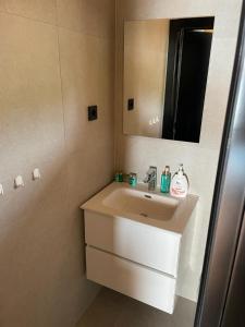 a bathroom with a sink and a mirror at Golden Haven Luxe Glamp Resort in Murter