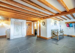 a living room with a wooden ceiling at Knipe Fold Barn in Hawkshead