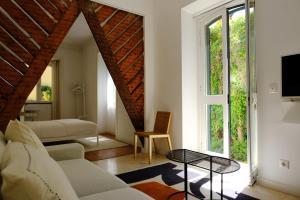 a living room with a couch and a table at Lisbon City Villa in Lisbon