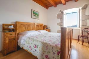 a bedroom with a bed and a table and a window at Villa Veli Palac in Baška