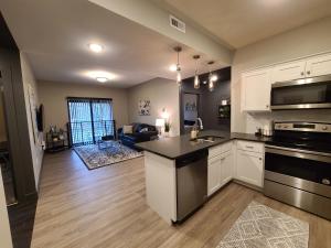 a kitchen with a sink and a stove top oven at 520 Neil Luxury 2 Bedroom in Champaign