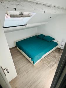 een slaapkamer met een bed in een kleine kamer bij SUPERBE DUPLEX DESIGN NEUF 2 CHAMBRES, CLIMATISE TOUT CONFORT, FACILE D,ACCES STATIONNEMENT GRATUIT in Marseille