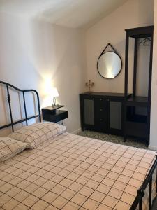 a bedroom with a bed with a mirror and a dresser at Land and Sea in Primošten