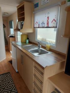 a small kitchen with a sink and a window at Betty's Place in Whitley Bay