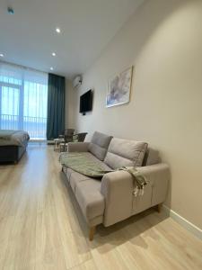 a living room with a couch and a table at Aktau Riviera in Aktau