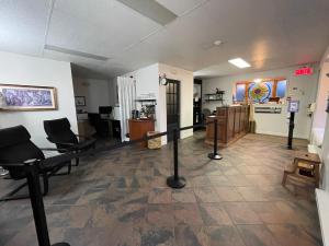 a hair salon with chairs and a barber shop at Hotel Le Pionnier in Tadoussac