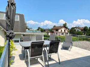 a patio with a table and chairs and an umbrella at Apartment Sunshine in Höchst