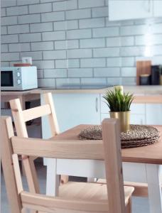 a wooden table with two chairs and a plant on it at Isamena in Las Playas