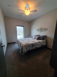 a bedroom with a bed and a ceiling fan at 520 Neil Heart of Downtown Champaign in Champaign